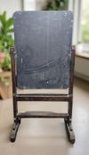 A late 19th century stained pine framed revolving chalk board on stand, 94 cm W x 182 cm H.