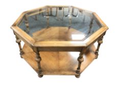 A reproduction octagonal two tier coffee table with bevelled glass inset top, width 97 cm.