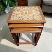 A G Plan teak tile inset nest of three tables, width 50 cm.