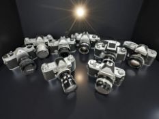A collection of 35mm film cameras two include two Nikkormat examples, Honeywell Pentax, Miranda D,