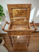 An Edwardian storage piano stool.