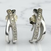 A pair of 9ct white gold diamond half-hoop earrings, the stated total diamond weight 0.
