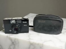 A Rollei 35B 35mm film camera with Triotar 3,5/40mm lens, in fitted leather pouch.