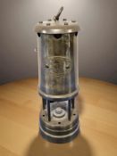A Lamp & Limelight miner's brass safety lamp.