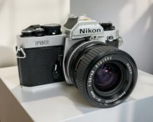 A Nikon FM2 35mm film camera with Zoom-Nikkor 35-70mm 1:3.3-4.5 lens.