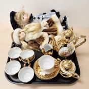 A Bondware gold layered tea set and two dolls.