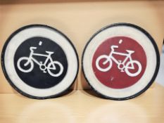 Two painted tin cycling signs, diameter 50 cm.