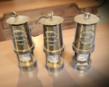 Three miniature brass miner's lamps, height 10 cm.