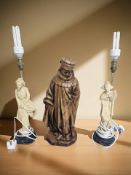 A carved wooden statue of a monk, height 45 cm, and a pair of oriental resin table lamps.