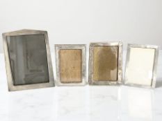 Four silver-mounted photo frames, the largest an Art Deco example hallmarked Birmingham 1930,