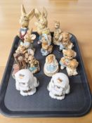 A group of Pendelfin rabbits and a pair of porcelain figures of owls.
