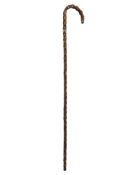 An antique walking stick with silver mounts.