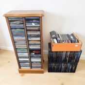 A CD rack, assorted CDs and two classical box sets.