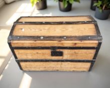 An antique pine and metal bound domed trunk, width 71 cm.