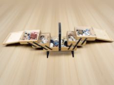 A concertina sewing box and contents.