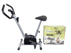 An exercise bike and a Wonder Core work out device in box
