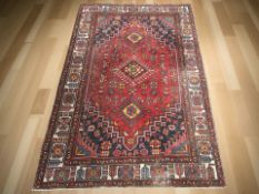 An Iranian rug, 217 cm x 146 cm.