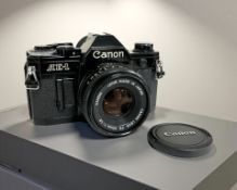 A Canon AE-1 35mm film camera, with Canon FD 50mm 1:1.8 lens.