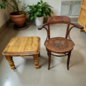 A reproduction stained wooden lamp table and a bentwood armchair.