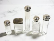 Three silver-lidded crystal dressing table bottles, George Henry James, London 1904,