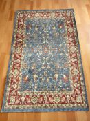 A machine made rug of Iranian design on blue ground,