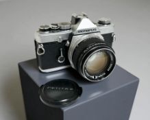 An Olympus OM-1 35mm film camera with Olympus G. Zuiko Auto-S 1:1.4 f=50mm lens.