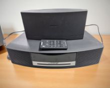 A Bose Wave music system and a further DAB module, with leads and a remote.
