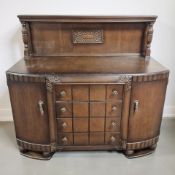 A 20th century carved and stained oak bow front buffet sideboard, 137 cm x 57 cm x 125 cm.