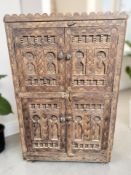 An eastern carved hardwood four door cabinet, 82 cm x 35 cm x 130 cm.
