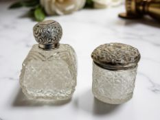 Two cut-crystal silver-lidded dressing table jars, tallest 11.