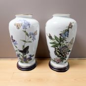 A pair of Franklin porcelain butterfly vases designed by John Wilkinson, on turned wooden stands,