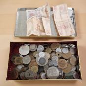 A shallow tin containing assorted British and foreign coins including Victorian silver crown 1898,
