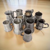A group of antique pewter and EPNS tankards and mugs.