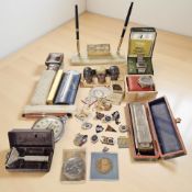 An Art Deco onyx desk stand, an oversized Smiths pocket watch, lighters, a Hohner Superchromonica,