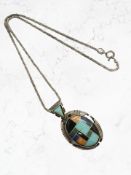 A silver enamelled pendant on chain