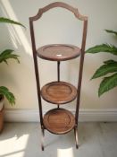A mahogany three tier cake stand.
