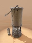 A brass Ferndale Coal and Mining Co. miner's safety lamp, and a further miniature example.