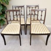 A set of four reproduction mahogany dining chairs.