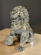A silvered composition figure of a temple dog, height 27 cm.