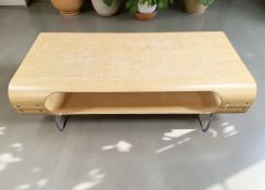 An IKEA bent and laminated wood entertainment stand on metal legs, width 119 cm.