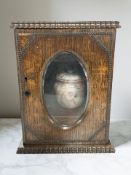 A Victorian oak smoker's cabinet containing a tobacco jar, height 30 cm.