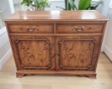 A reproduction yew wood double door side cabinet, 107 cm x 43 cm x 82 cm.