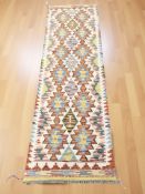 A Chobi Kilim runner, 207 cm x 61 cm.