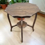 An Edwardian walnut two tier occasional table, diameter 63 cm.