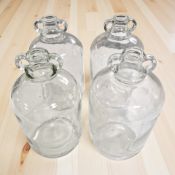Four 5 litre glass demijohns, height 30 cm.