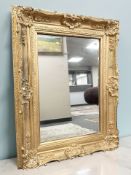 An antique style bevelled mirror, 96 cm x 127 cm.