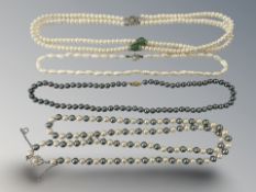 Four pearl necklaces, one with yellow gold clasp.