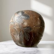 A 19th century carved coconut with pineapple and coconut tree motifs, height 11 cm.