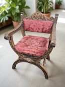 A heavily-carved oak Savonarola-style armchair, width 65 cm.