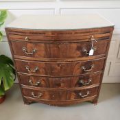 A 20th century mahogany bow front four drawer chest with brushing slide, 77 cm x 52 cm x 82 cm.